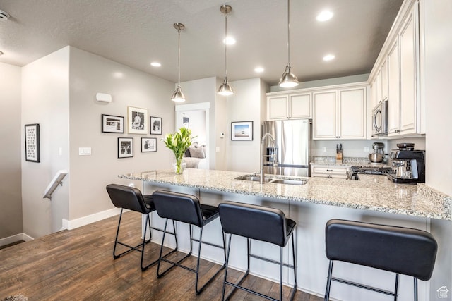 1722 W Naxos Ln, South Jordan, UT 84095 - kitchen featuring stainless steel appliances, dark wood-type flooring, baseboards, a peninsula, and recessed lighting