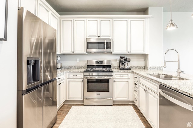 1722 W Naxos Ln, South Jordan, UT 84095 - kitchen with stainless steel appliances, a sink, dark wood-type flooring, and white cabinetry