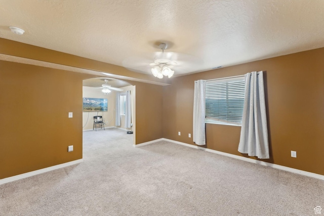 192 Starboard Ln, Stansbury Park, UT 84074 - carpeted spare room with a ceiling fan, baseboards, a textured ceiling, and a smoke detector