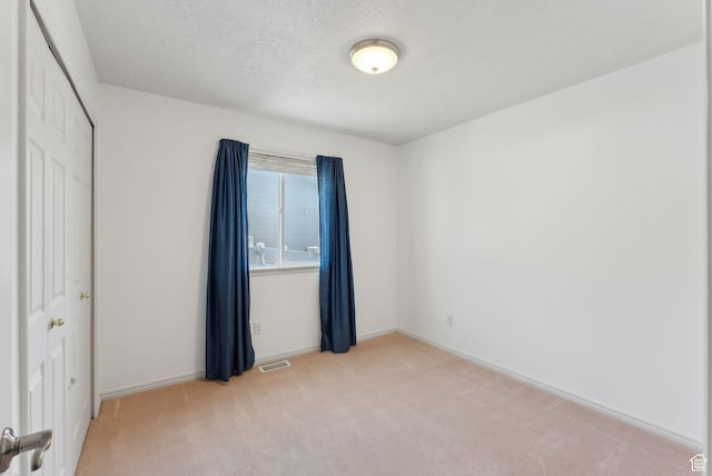 192 Starboard Ln, Stansbury Park, UT 84074 - unfurnished bedroom featuring light colored carpet, a closet, and baseboards