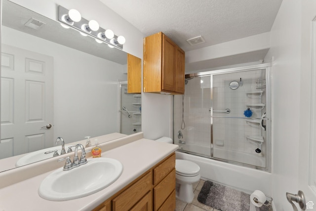 192 Starboard Ln, Stansbury Park, UT 84074 - bathroom with toilet, vanity, tile patterned floors, bath / shower combo with glass door, and a textured ceiling