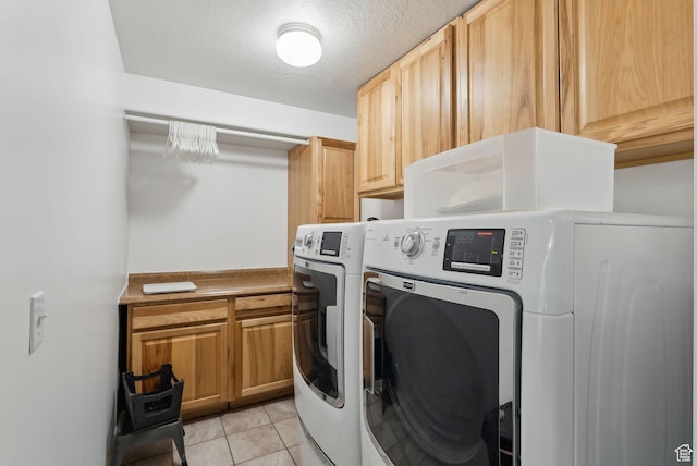 192 Starboard Ln, Stansbury Park, UT 84074 - laundry area with washer and clothes dryer, cabinet space, light tile patterned floors, and a textured ceiling