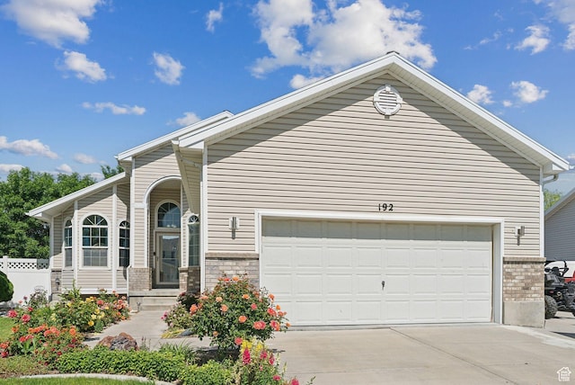 192 Starboard Ln, Stansbury Park, UT 84074 - view of front of house featuring brick siding, concrete driveway, and an attached garage