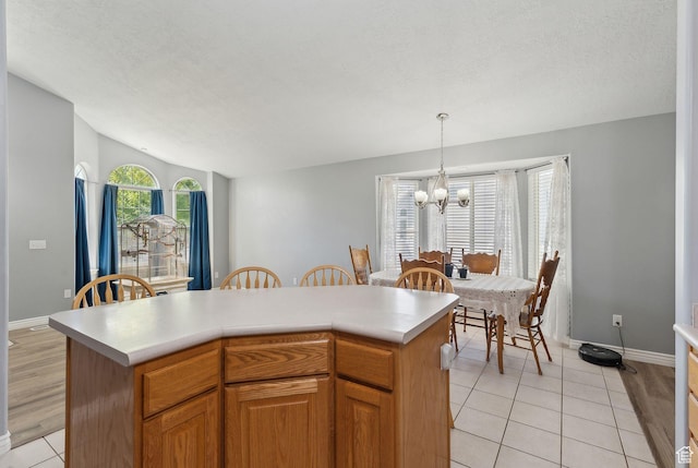 192 Starboard Ln, Stansbury Park, UT 84074 - kitchen with a chandelier, light countertops, light tile patterned flooring, decorative light fixtures, and baseboards
