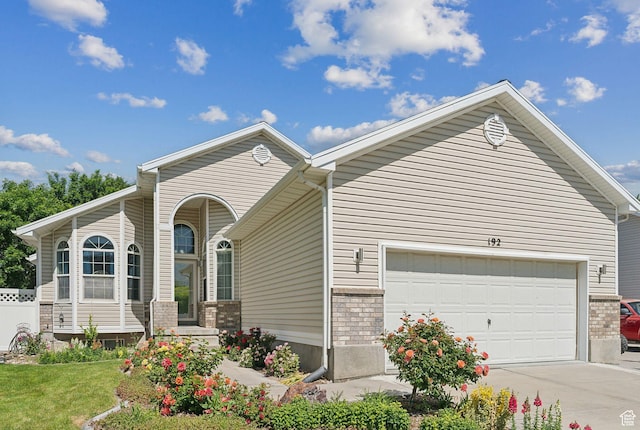 192 Starboard Ln, Stansbury Park, UT 84074 - ranch-style home with concrete driveway, a garage, a front lawn, and brick siding