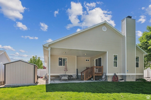 192 Starboard Ln, Stansbury Park, UT 84074 - rear view of house featuring a patio, a chimney, and a yard
