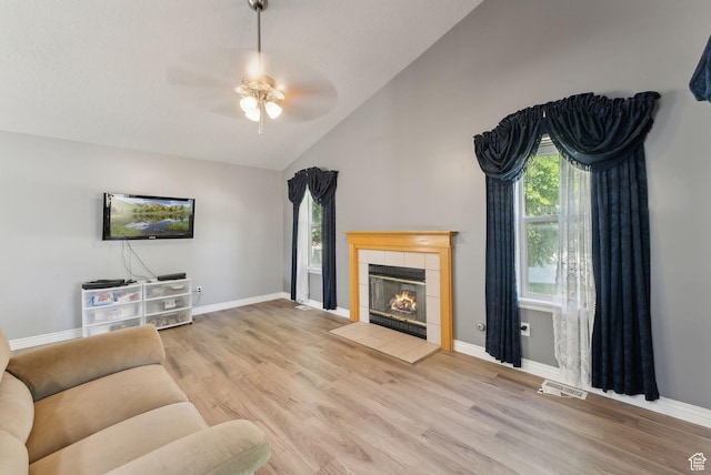 192 Starboard Ln, Stansbury Park, UT 84074 - living room with ceiling fan, plenty of natural light, wood finished floors, a fireplace, and high vaulted ceiling