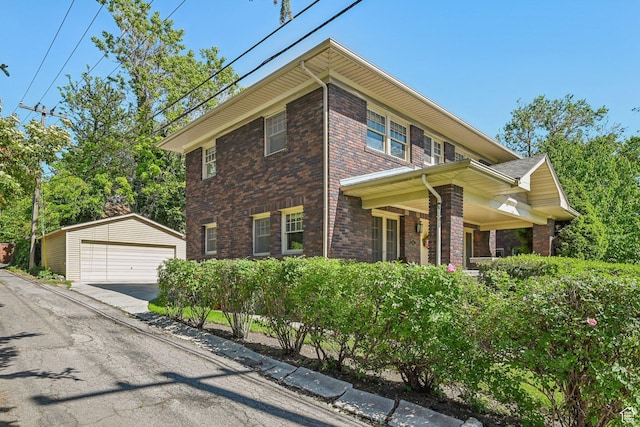 114 N Virginia St, Salt Lake City, UT 84103 - view of front of house with a detached garage, brick siding, and an outdoor structure