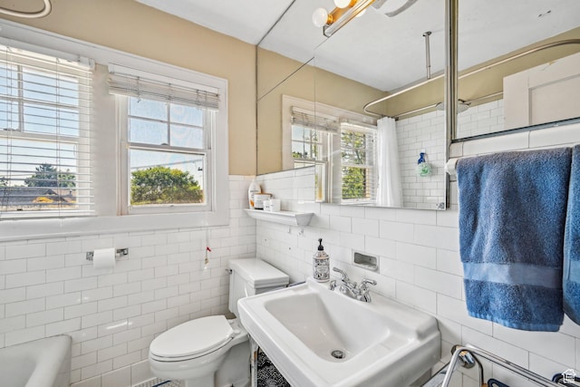 114 N Virginia St, Salt Lake City, UT 84103 - full bath featuring tile walls, a sink, toilet, curtained shower, and a tub to relax in