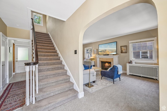 114 N Virginia St, Salt Lake City, UT 84103 - stairway featuring radiator, arched walkways, healthy amount of natural light, and a lit fireplace