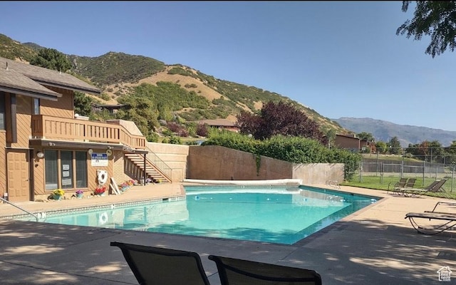 4968 S Partridge Way E, Ogden, UT 84403 - community pool featuring a mountain view, a fenced backyard, a patio, and stairs