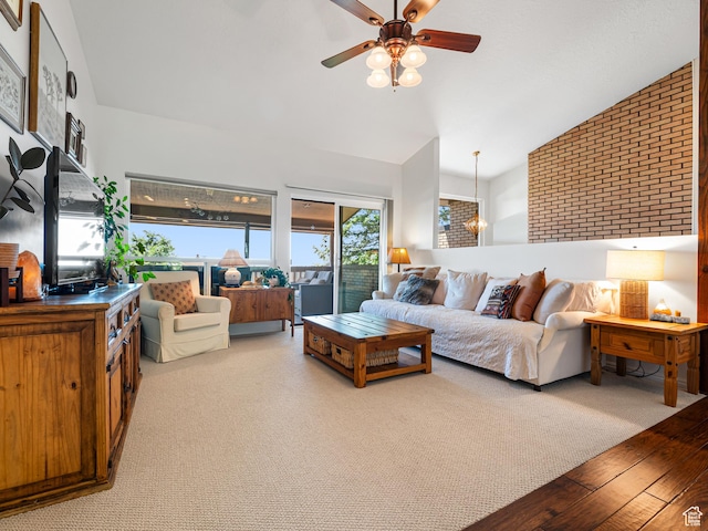4968 S Partridge Way E, Ogden, UT 84403 - living room with vaulted ceiling, a ceiling fan, brick wall, and wood finished floors