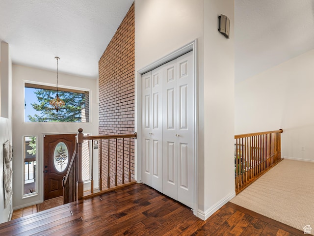 4968 S Partridge Way E, Ogden, UT 84403 - foyer with wood finished floors, a chandelier, high vaulted ceiling, and baseboards