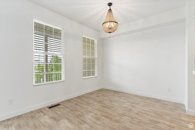 5377 W Bowstring Way S, Jordan, UT 84009 - spare room featuring a chandelier, baseboards, and light wood finished floors