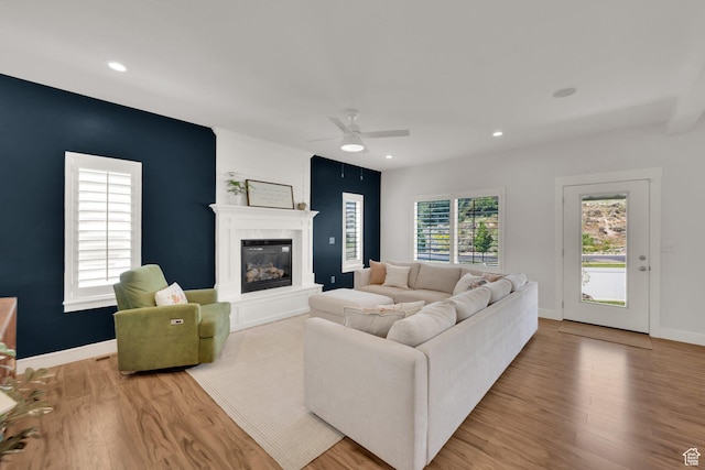 7859 N Sagebrush Ln, Eagle Mountain, UT 84005 - living area with wood finished floors, a fireplace, a ceiling fan, recessed lighting, and baseboards