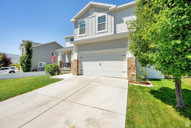 7859 N Sagebrush Ln, Eagle Mountain, UT 84005 - craftsman-style home with a garage, stone siding, a front yard, and driveway