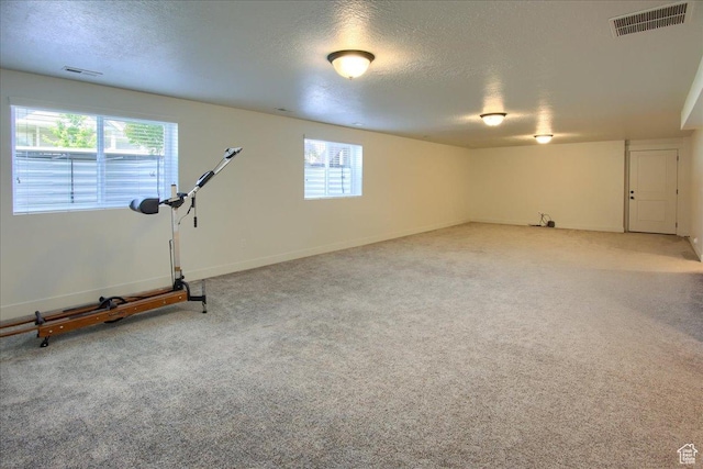 4016 W 625 S, West Point, UT 84015 - below grade area featuring plenty of natural light, a textured ceiling, carpet flooring, and baseboards