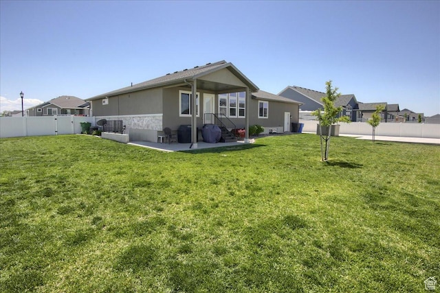 4016 W 625 S, West Point, UT 84015 - rear view of house with stucco siding and a patio area