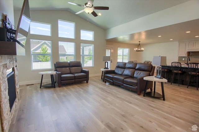 4016 W 625 S, West Point, UT 84015 - living area with ceiling fan, a stone fireplace, light wood finished floors, high vaulted ceiling, and recessed lighting