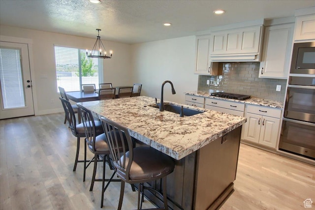 4016 W 625 S, West Point, UT 84015 - kitchen with a sink, gas cooktop, built in microwave, light wood finished floors, and recessed lighting