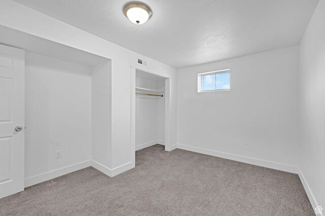 6975 N 2650 W, Honeyville, UT 84314 - unfurnished bedroom with a textured ceiling, carpet floors, baseboards, and a closet
