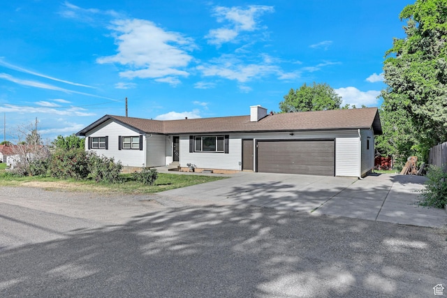 6975 N 2650 W, Honeyville, UT 84314 - single story home featuring an attached garage, driveway, and a chimney