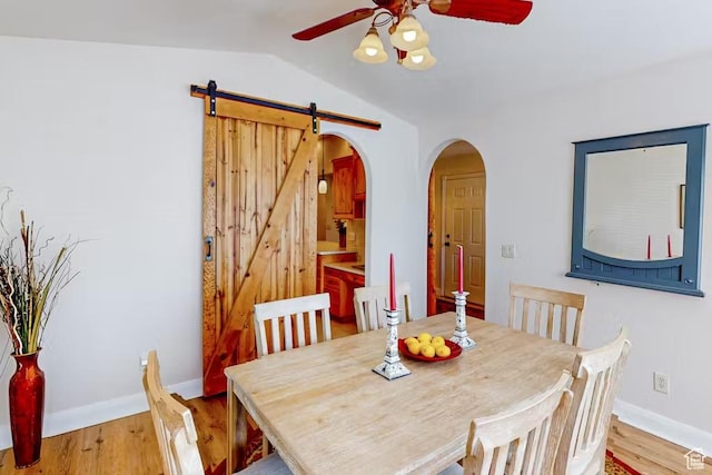1096 S Bentley Blvd, Cedar City, UT 84720 - dining space with ceiling fan, arched walkways, vaulted ceiling, baseboards, and a barn door