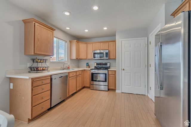 775 N 250 W, Springville, UT 84663 - kitchen featuring appliances with stainless steel finishes, a sink, light wood finished floors, light countertops, and recessed lighting