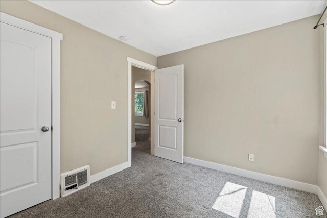 917 E Sullivan Rd, Ogden, UT 84403 - unfurnished bedroom featuring carpet, baseboards, and arched walkways