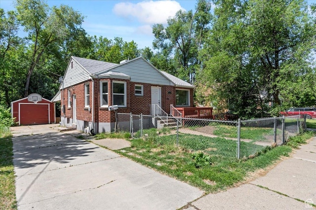 917 E Sullivan Rd, Ogden, UT 84403 - bungalow featuring brick siding, an outbuilding, a fenced front yard, driveway, and a detached garage