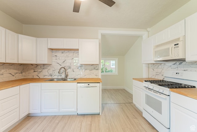 3180 Porter Ave, Ogden, UT 84403 - kitchen featuring white appliances, wood counters, light wood-style floors, decorative backsplash, and vaulted ceiling