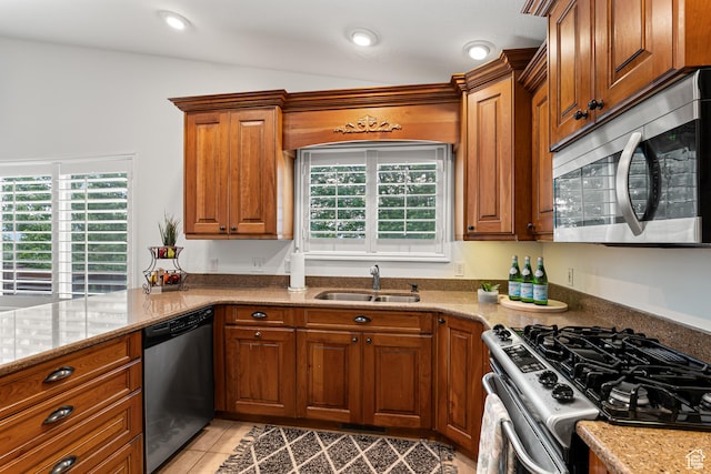 11770 S Dry Creek Rd, Sandy, UT 84094 - kitchen with appliances with stainless steel finishes, a sink, brown cabinetry, light stone counters, and recessed lighting