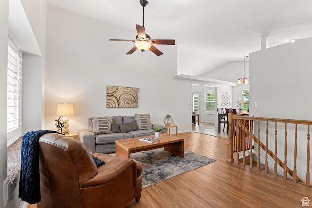 11770 S Dry Creek Rd, Sandy, UT 84094 - living room with ceiling fan, lofted ceiling, wood finished floors, a chandelier, and baseboards
