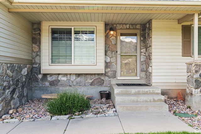 11770 S Dry Creek Rd, Sandy, UT 84094 - view of exterior entry featuring stone siding and covered porch