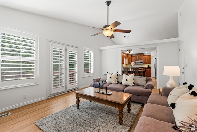 11770 S Dry Creek Rd, Sandy, UT 84094 - living room with ceiling fan, light wood-style flooring, healthy amount of natural light, vaulted ceiling, and baseboards