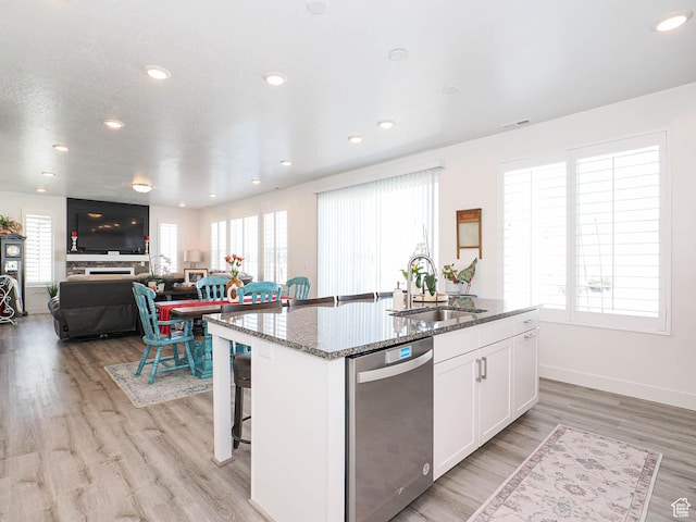 3022 S Shoreline Dr W, Syracuse, UT 84075 - kitchen featuring dishwasher, a sink, a kitchen island with sink, white cabinets, and stone counters
