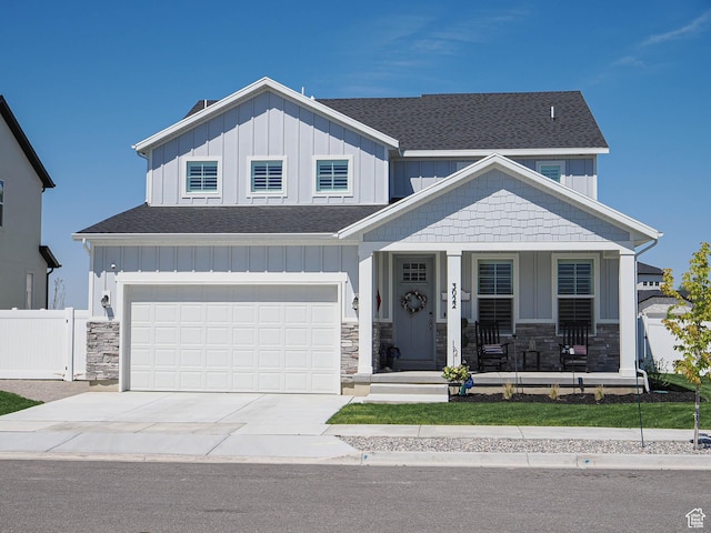 3022 S Shoreline Dr W, Syracuse, UT 84075 - craftsman-style house featuring board and batten siding, covered porch, a shingled roof, and driveway