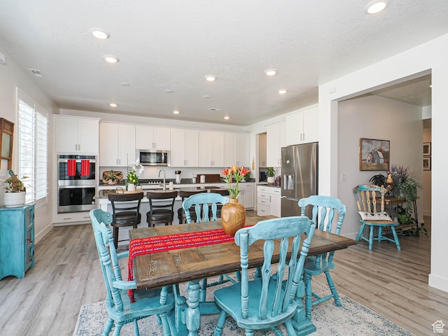 3022 S Shoreline Dr W, Syracuse, UT 84075 - dining room with light wood-style floors, recessed lighting, and baseboards