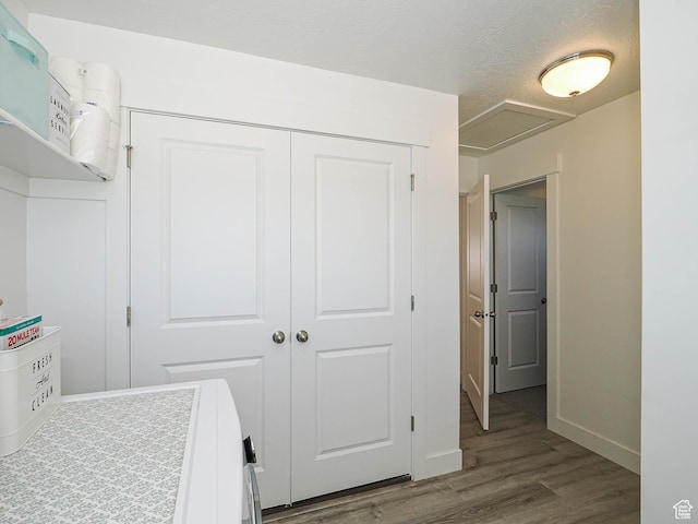 3022 S Shoreline Dr W, Syracuse, UT 84075 - bedroom with dark wood-type flooring, a closet, baseboards, washing machine and clothes dryer, and attic access