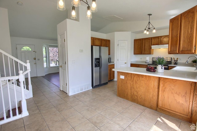 8183 S 2420 W, West Jordan, UT 84088 - kitchen with stainless steel appliances, under cabinet range hood, a sink, vaulted ceiling, and light countertops