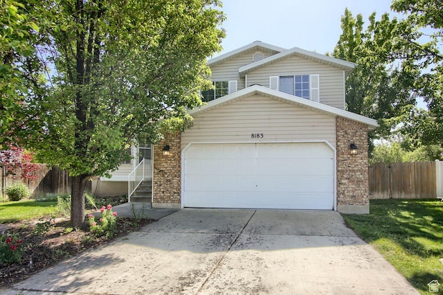 8183 S 2420 W, West Jordan, UT 84088 - view of front of property with a garage, driveway, and brick siding
