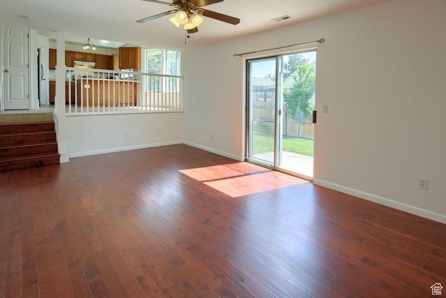 8183 S 2420 W, West Jordan, UT 84088 - unfurnished living room with ceiling fan, baseboards, dark wood-type flooring, and stairs