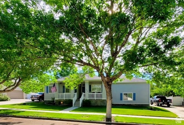 1913 N 370 W, Tooele, UT 84074 - view of front facade with a porch, a front lawn, and stucco siding