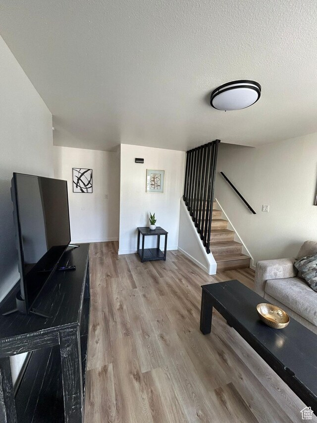 1350 W 150 N Unit 22, Vernal, UT 84078 - living room with stairs, wood finished floors, and a textured ceiling