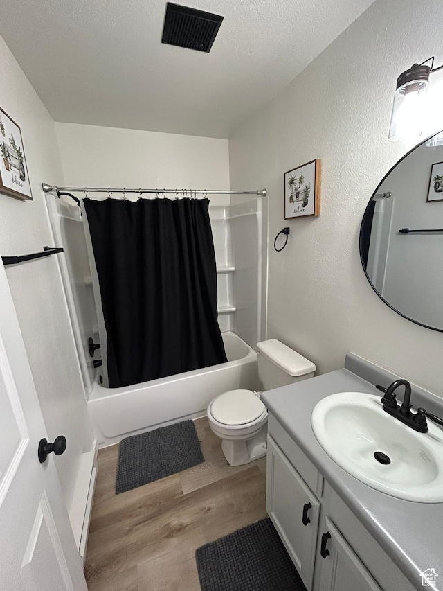 1350 W 150 N Unit 22, Vernal, UT 84078 - bathroom featuring wood finished floors, vanity, shower / bath combo with shower curtain, toilet, and a textured ceiling