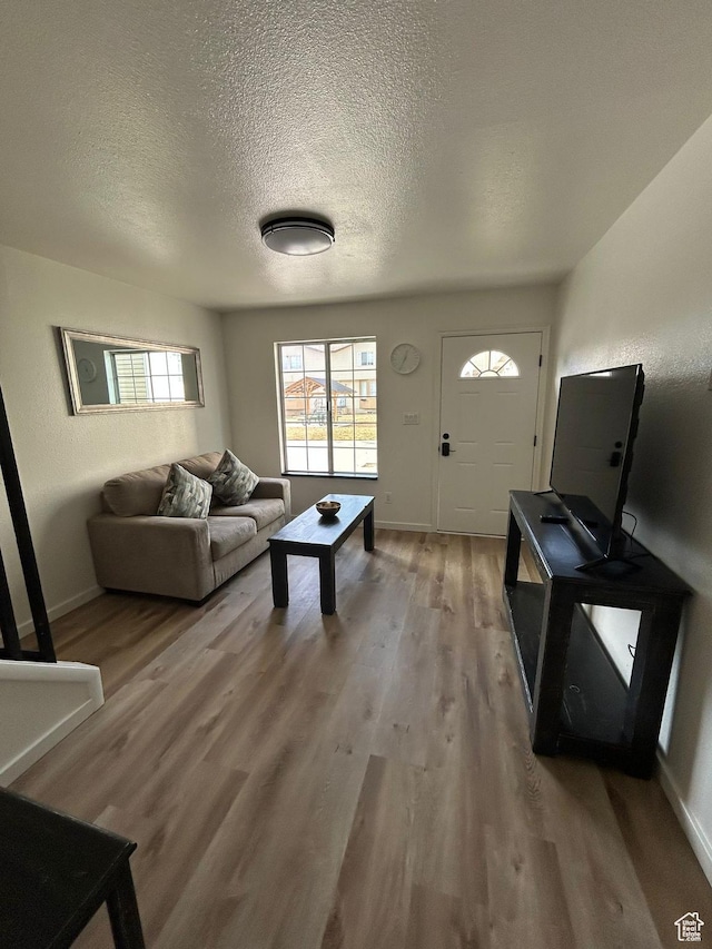 1350 W 150 N Unit 22, Vernal, UT 84078 - living area featuring light wood-type flooring, a textured ceiling, and baseboards