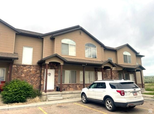 1658 W 300 S Unit 43, Vernal, UT 84078 - view of property featuring uncovered parking and stone siding