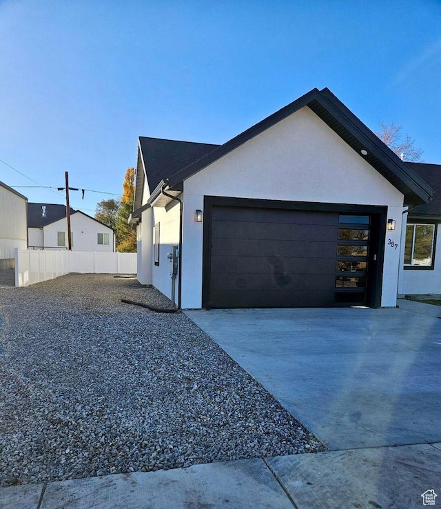 387 N 300 E, Payson, UT 84651 - view of side of property with stucco siding, concrete driveway, and an attached garage