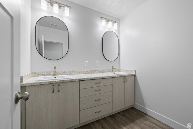 387 N 300 E, Payson, UT 84651 - full bath with double vanity, wood finished floors, and a textured ceiling
