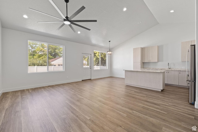 387 N 300 E, Payson, UT 84651 - unfurnished living room featuring ceiling fan, light wood-type flooring, recessed lighting, a chandelier, and high vaulted ceiling